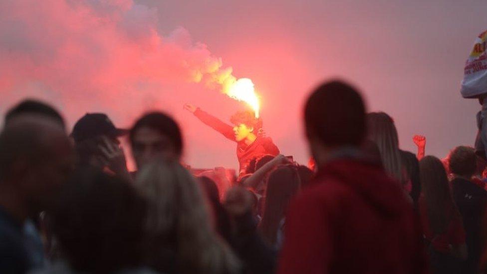 Liverpool fans let off flares outside the Liver Building in Liverpool.