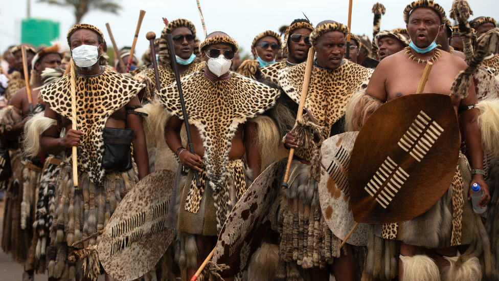 Zulu men in traditional warrior outfits with shields in Nongoma, South Africa - 17 March 2021