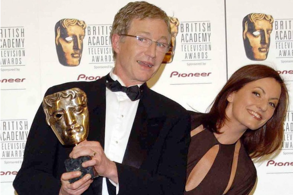 Paul O'Grady (standing alongside Davina McCall) holding his Bafta statue