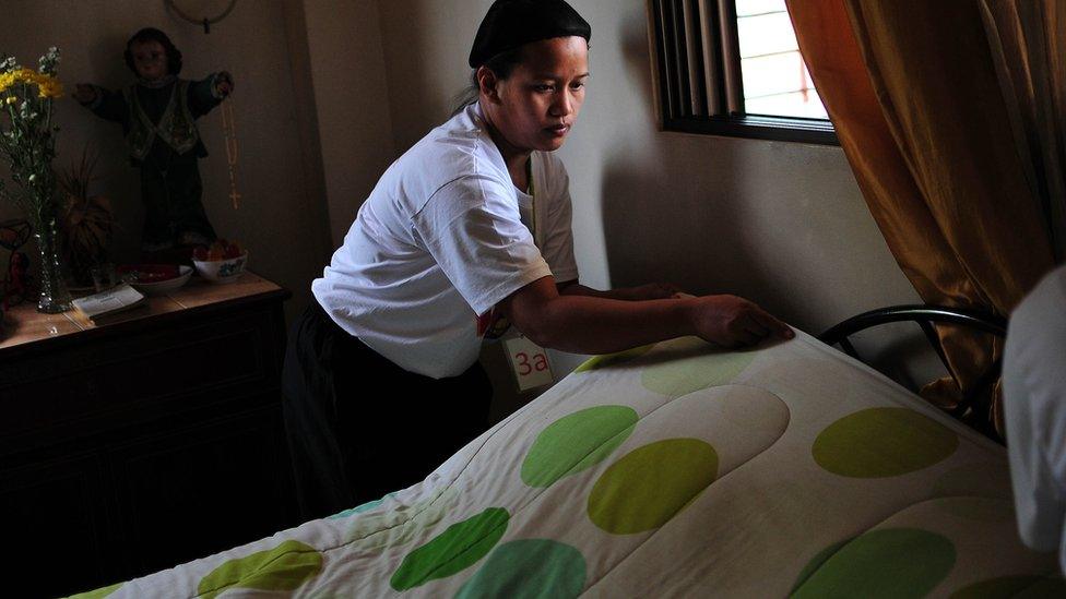 Filipino trainees are tested on their skills on housekeeping as part of their requirement before working abroad on September 10, 2013 in Manila, Philippines.