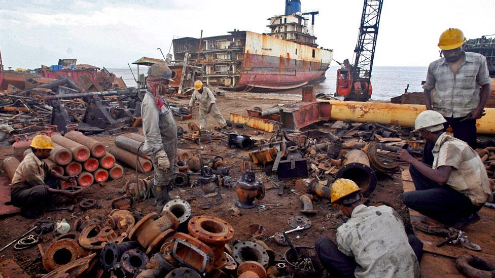 Workers dismantle a decommissioned ship at the Alang shipyard, 2007