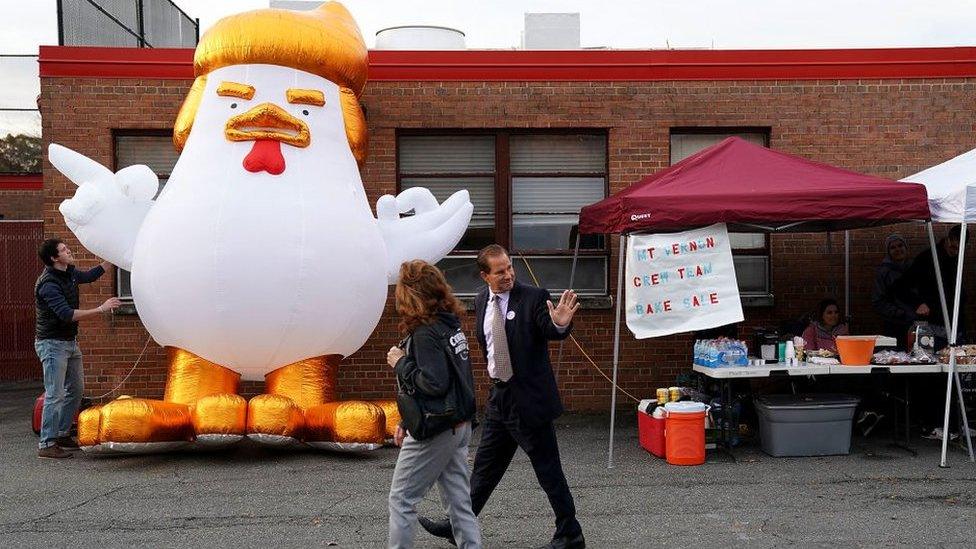 Supporters of Democrat Ralph Northam displayed a cartoon chicken made to resemble Trump outside a polling place in Virginia