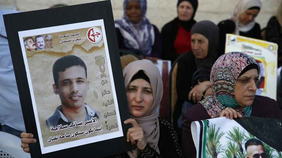 Families of Palestinians imprisoned in Israeli jails demonstrate in front of the Red Cross offices in east Jerusalem on May 17, 2017, as hundreds of the detainees entered the second month of a hunger strike.