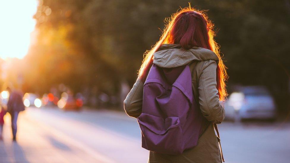 Teenager wearing school bag