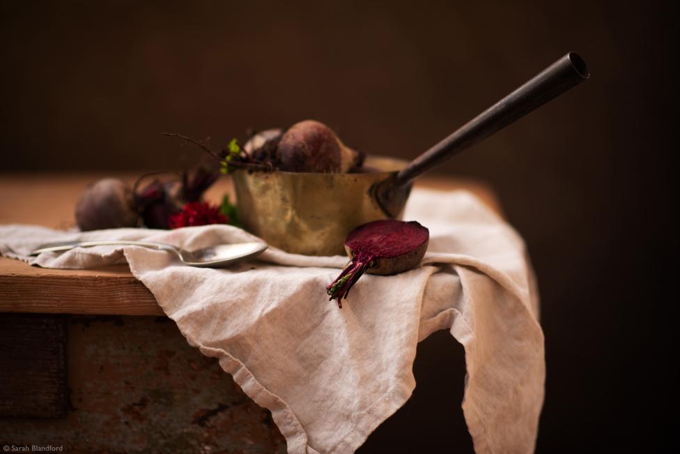 Beetroots in a pan on white fabric