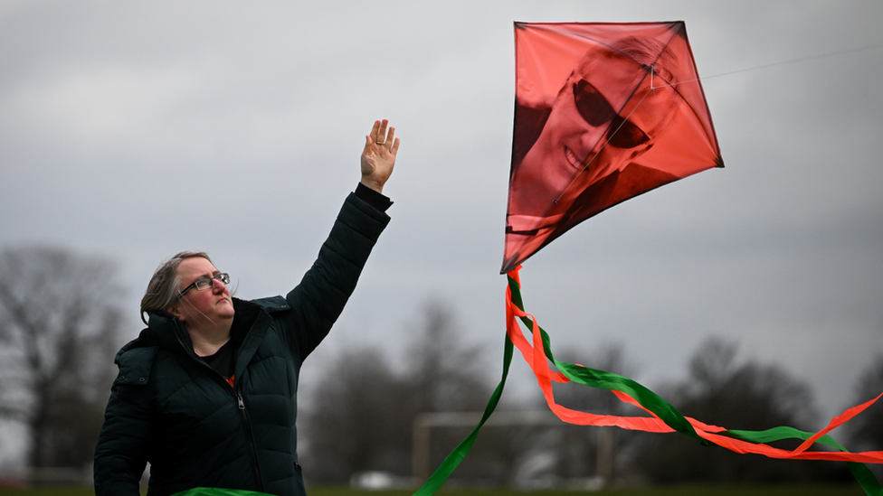 Woman releasing a kite