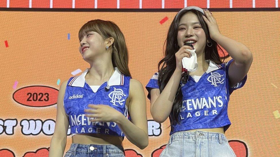 K-pop band members wearing Rangers tops