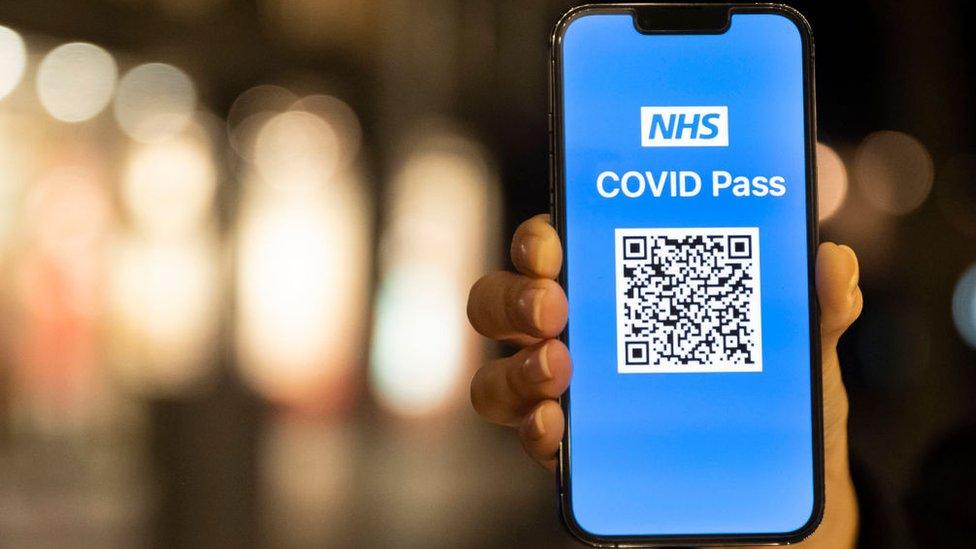 Covid pass app being shown in Cardiff