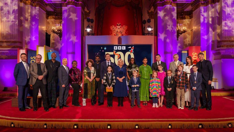 Queen Camilla on stage with the winners of the ˿'s 500 words writing competition