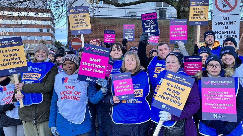 Nurses outside York Hospital holding up signs on the picket line