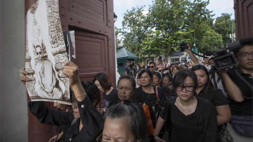 Mourners enter the Grand Palace in Bangkok to pay their respects to the king who died on Thursday, 15 October 2016