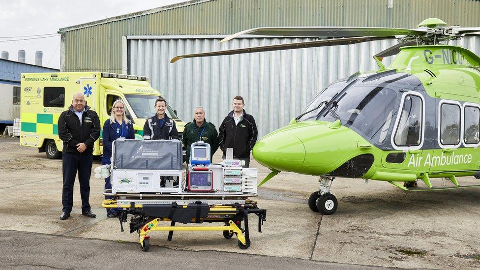 Bristol Nest team in front of a land and air ambulance