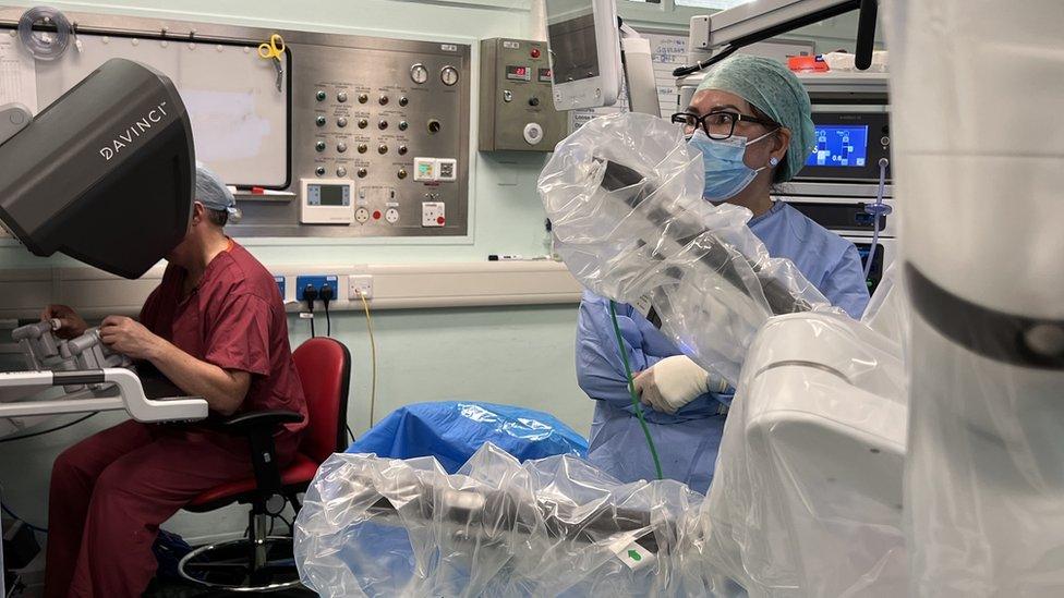 Surgeon Doug Whitelaw at the computer console which guides the robot