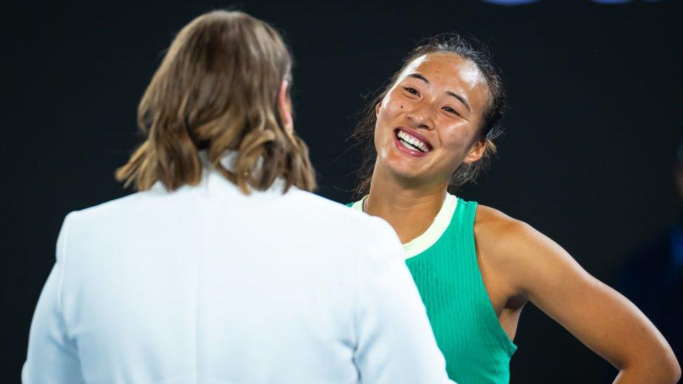 Zheng speaking to an interviewer in her post-match chat after her semi-final victory on 25 January