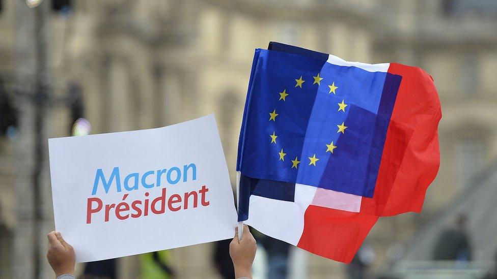 A European and French flag at the Louvre on 7 May