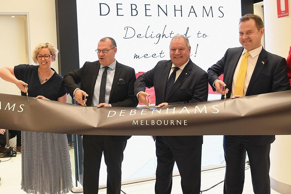 Staff cut a ribbon at an Debenham's store