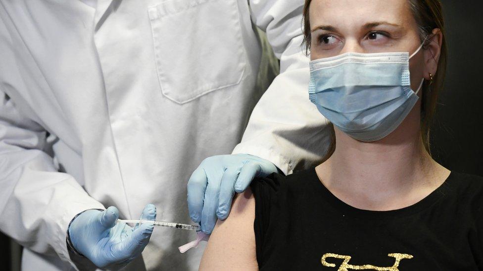 A doctor in the Netherlands receives the Moderna vaccination