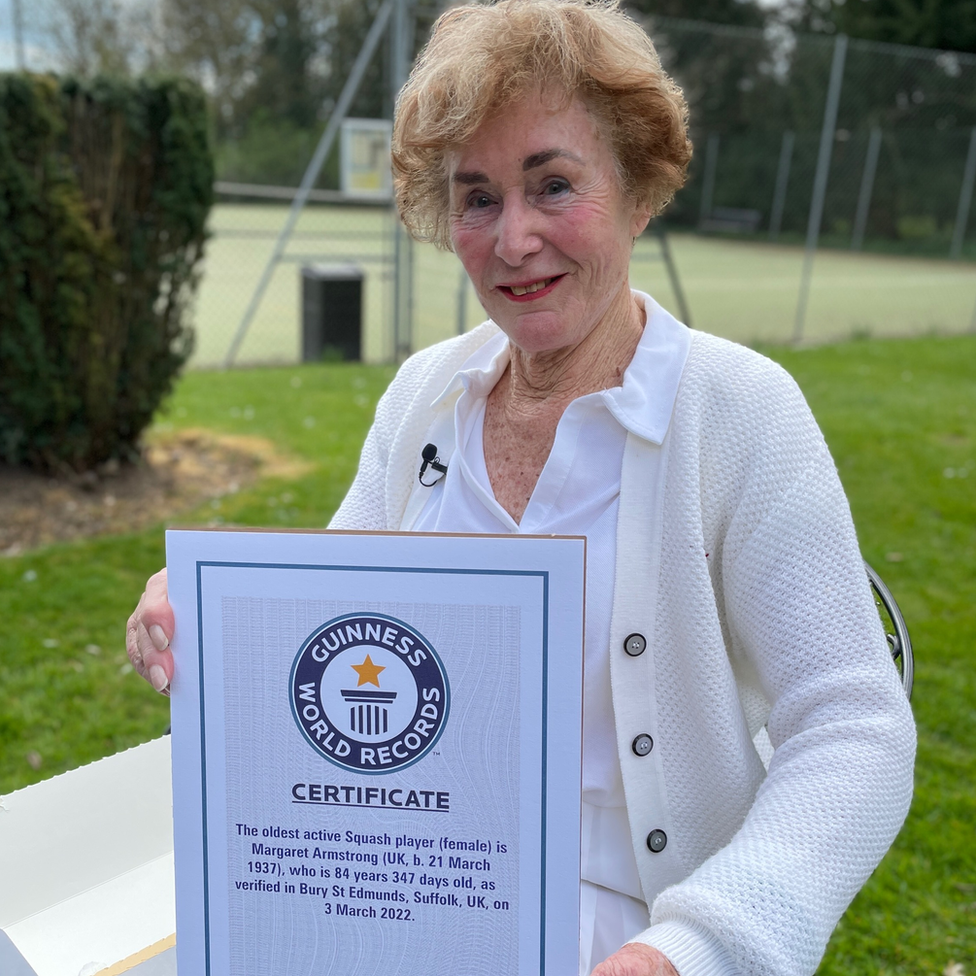 Margaret Armstrong, with her certificate showing she is the world's oldest active female squash player