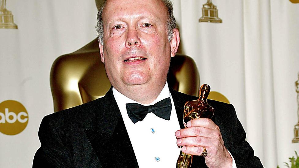 Julian Fellowes holding his Oscar