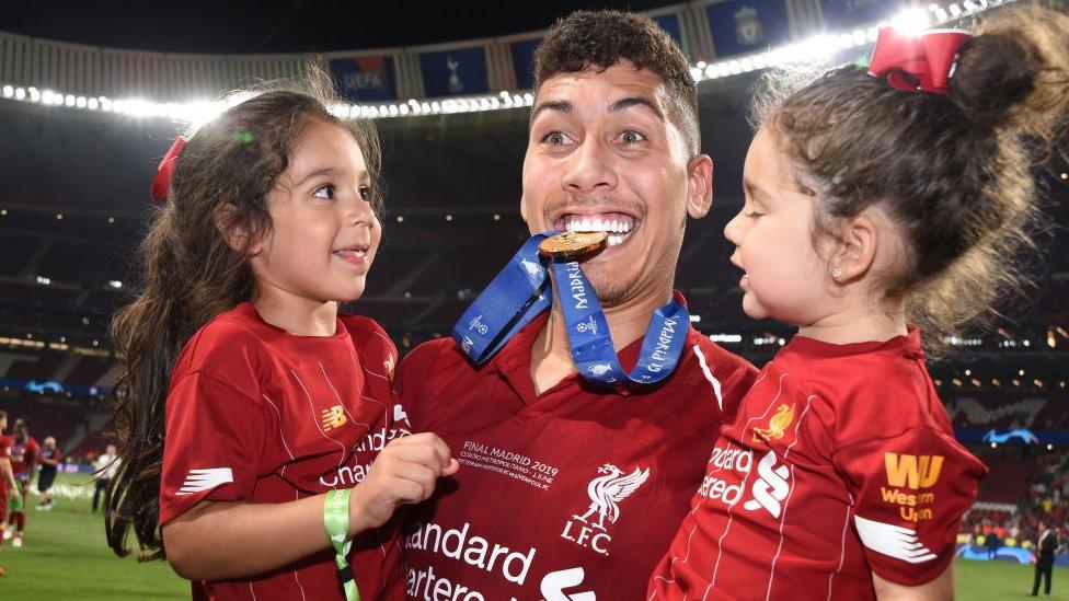 Roberto Firmino of Liverpool celebrates the win with his daughters