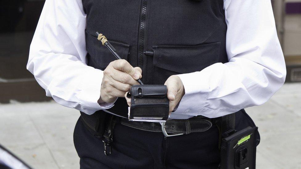 Traffic warden giving a ticket