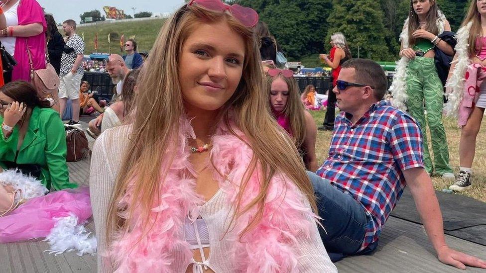 Young woman wearing a feather boa