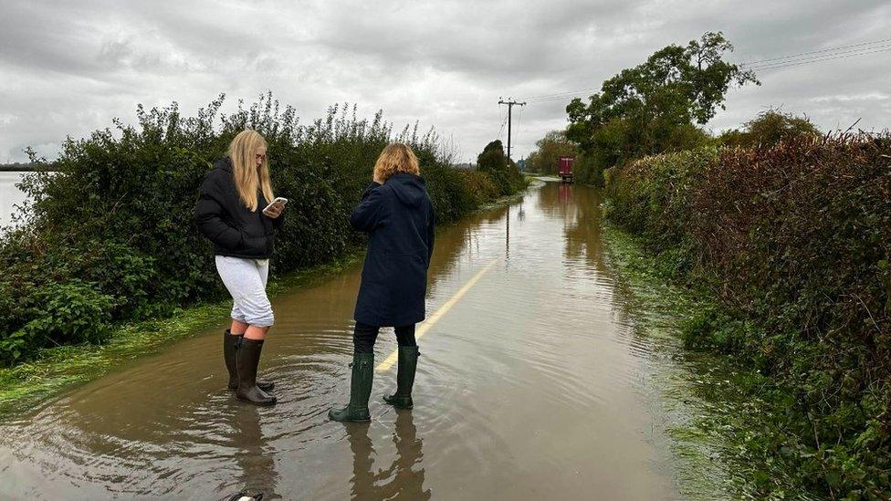 Flooded residents on the road