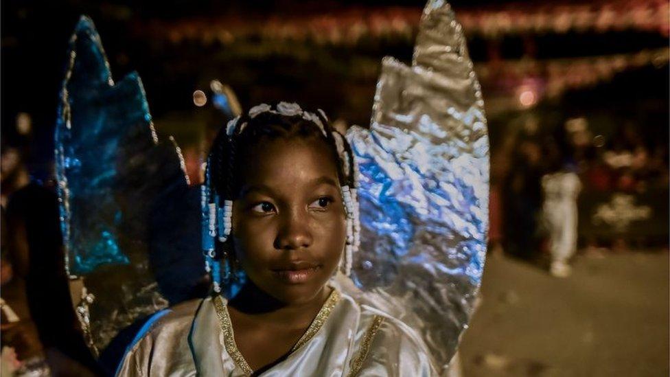 An Afro-Colombian girl in an angel costume takes part in the "Adoraciones al Nino Dios" celebrations in Quinamayo, department of Valle del Cauca, Colombia, on February 18, 2018.