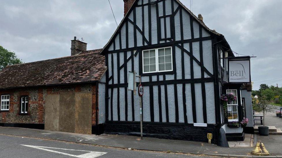 The boarded up hole in the wall where the car had gone into the Bell Inn in Kennett, Newmarket