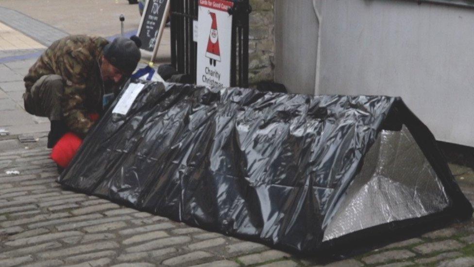 Christopher Sanderman who is newly homeless in Bristol getting into a sleep pod