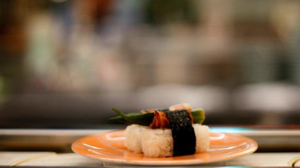 A plate of sushi rolls on the conveyor belt at Gourmet Sushiat restaurant, Japan.