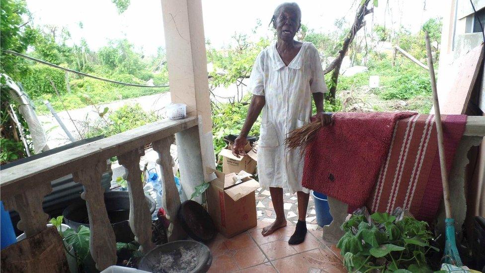 Miriam Harris indicates the old-fashioned coal-pot she has been cooking on in the absence of her kitchen