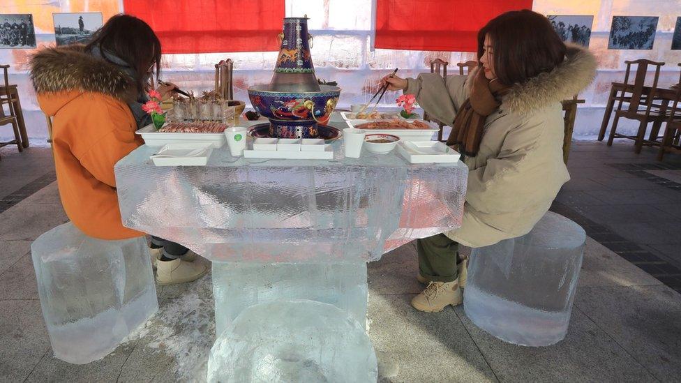 Women eating in the ice hotpot restaurant.