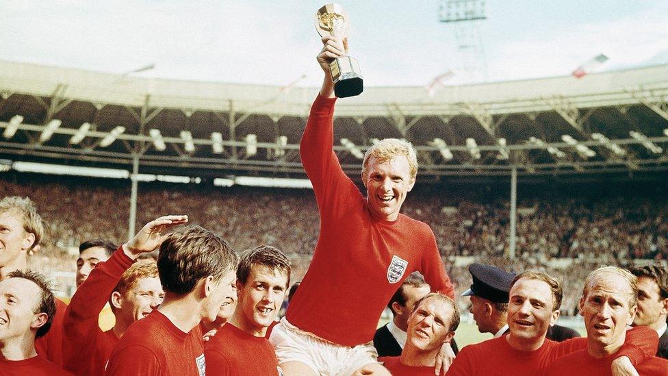 Bobby Moore celebrates England's World Cup win by lifting the Jules Rimet trophy