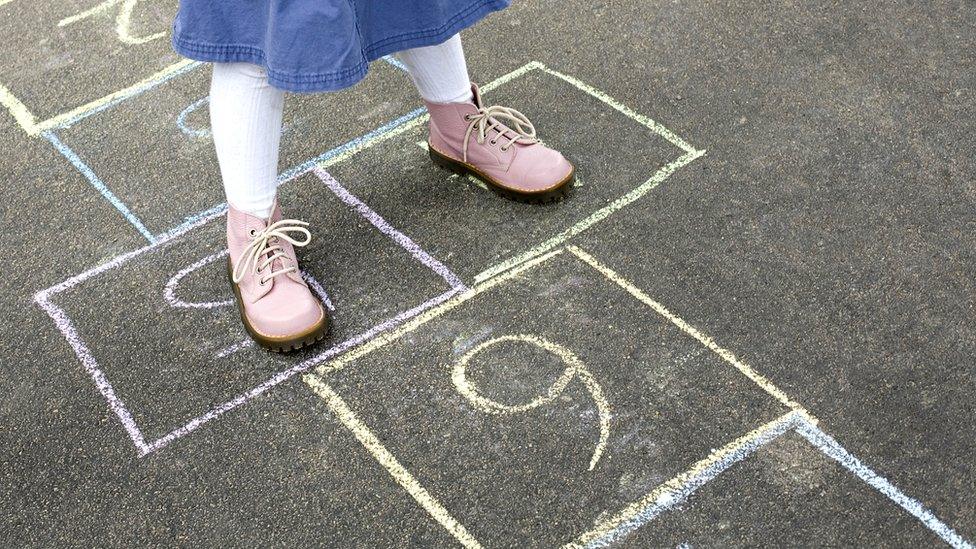 child playing hopscotch