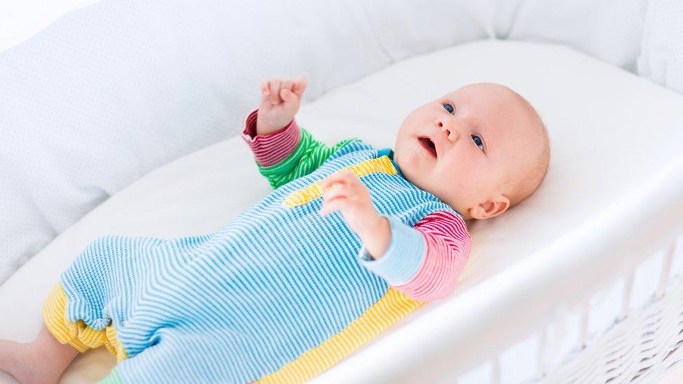 A baby in his cot