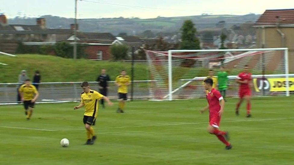 Ynysddu player kicking the ball