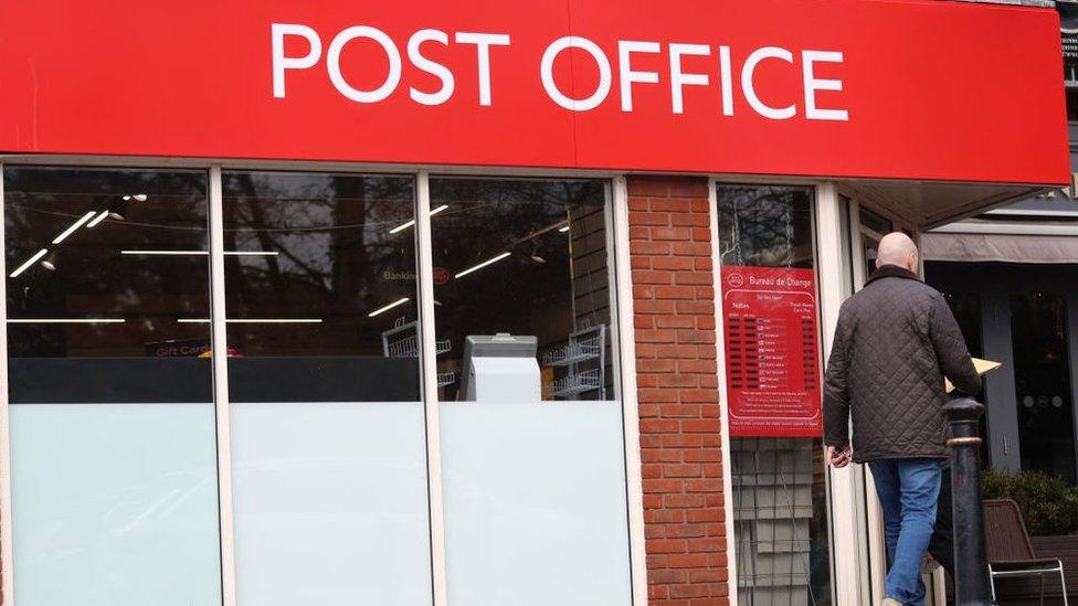 Man walking into Post Office