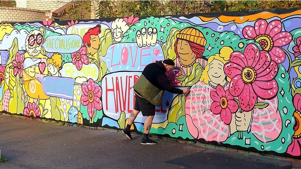 Joel Millerchip painting the mural