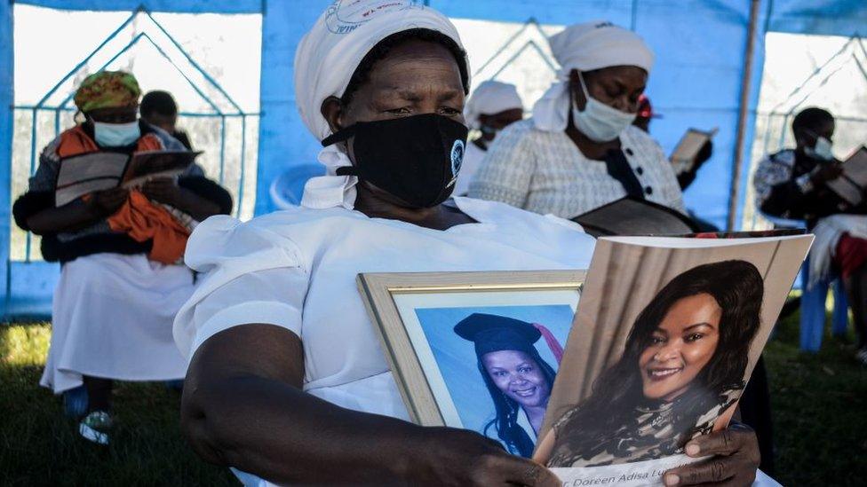 Grace Lugaliki holds portraits of her daughter Dr Doreen Lugaliki, 39, the first Kenyan doctor to die of Covid-19