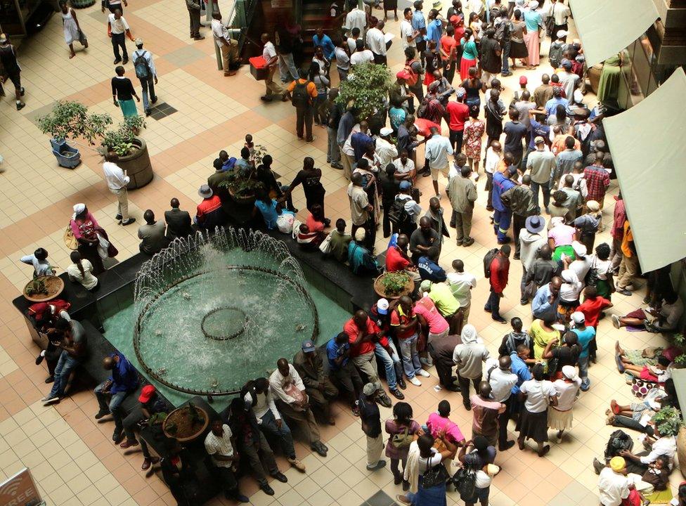 People queue to withdraw money from a bank in Harare, Zimbabwe"s capital, March 8, 2017.