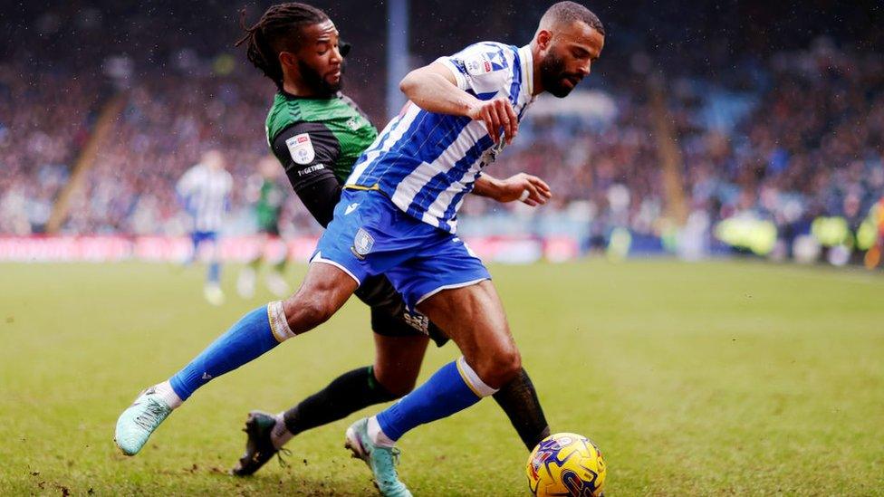 Michael Ihiekwe of Sheffield Wednesday is challenged by Kasey Palmer of Coventry City.