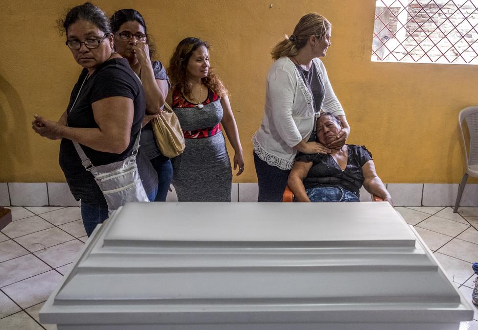 Friends and family of five-month-old Matías Pavón mourn next to his coffin in Managua in June 2018