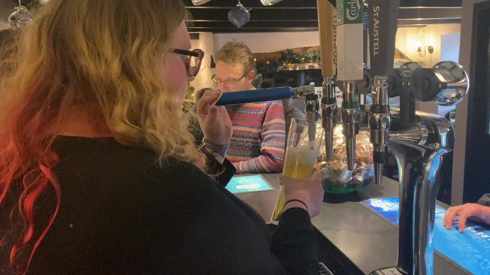 Woman pulling a pint