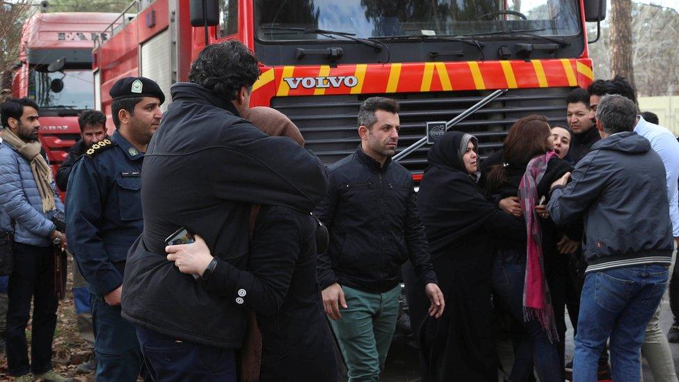 Rescue teams at wreckage site near Fath airport in Iran