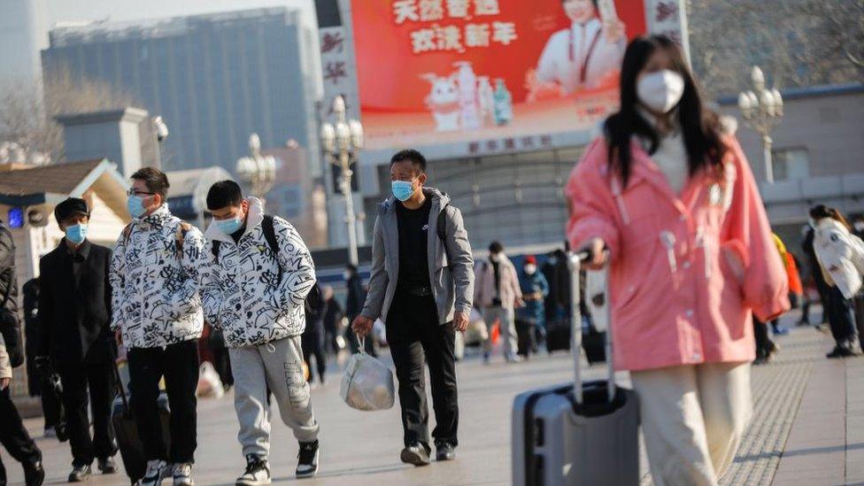 people outside Beijing railway station