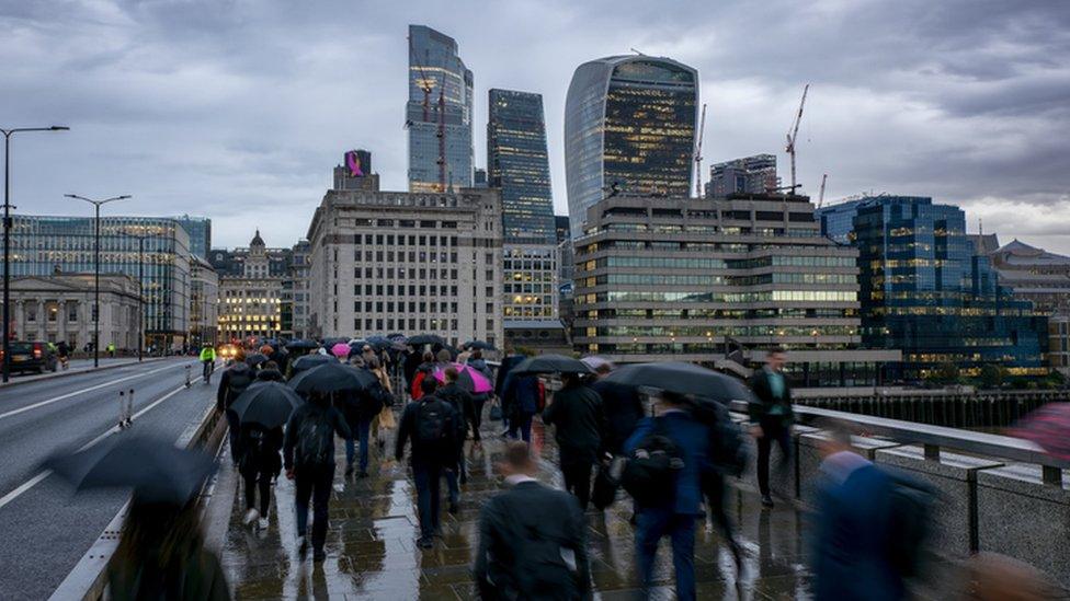 Workers crossing a bridge in London