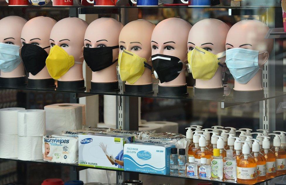 In-demand items, including face masks, latex gloves, hand sanitizers, soap and toilet roll are seen on display in a shop window in Brighton, southern England on March 21, 2020