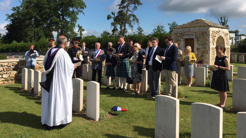 Maj Soutar's family and army personnel at his grave on Wednesday