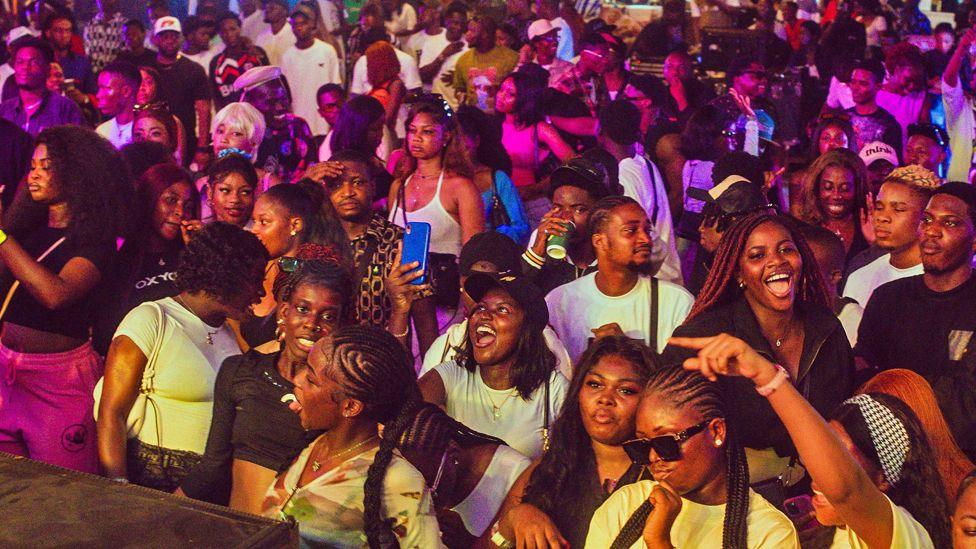 A crowd of young people in the audience looking at the stage at a music event during Detty December in Lagos, Nigeria, 2024